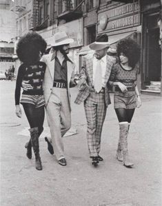 three men and two women walking down the street