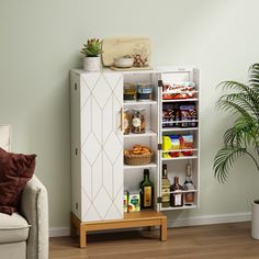 a white cabinet sitting next to a couch in a living room