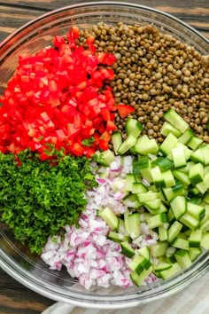 chopped up vegetables in a bowl on top of a wooden table