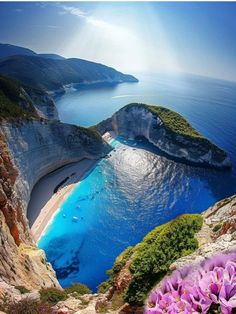 an aerial view of the blue waters and cliffs