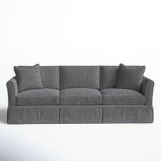 a gray couch sitting on top of a white floor