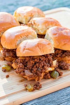 several sloppy joe sliders on a cutting board