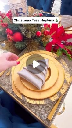 a table set for christmas with gold plates and napkins