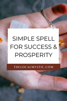 a hand holding a piece of paper with the words simple spell for success and prosperity