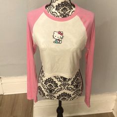 This Is A Pink And White Hello Kitty Long Sleeve Crop Top. It’s Ribbed And A Bit See Through. Also Has Some Wrinkles Due To Being In Storage, But Still In Good Condition Because It’s Brand New. Great For Any Hello Kitty Fan Fitted Hello Kitty Top For Spring, Fitted Hello Kitty Tops For Spring, Fitted Hello Kitty Crew Neck Top, Spring Fitted Hello Kitty Tops, Cute Hello Kitty Print Tops For Spring, Playful White Stretch Top, Hello Kitty Crew Neck Top, Hello Kitty Print Stretch Top For Summer, Stretch Hello Kitty Print Top For Summer