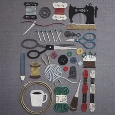 various sewing supplies laid out on top of a piece of gray fabric with scissors, yarn, and other items