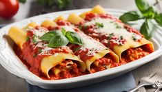 two ravioli stuffed with meat and sauce in a white dish