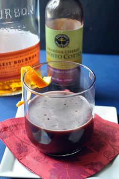 a drink in a glass with an orange slice on the rim