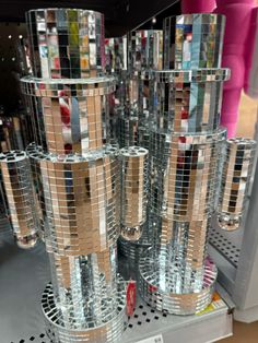 there are many glass cups on display in the store