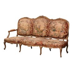 an old fashioned couch with floral tapestry on it's back and arms, sitting in front of a white background