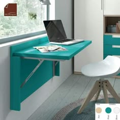 a laptop computer sitting on top of a blue desk next to a white chair in front of a window