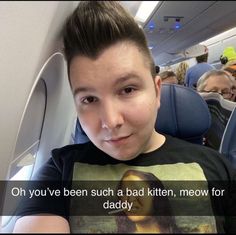 a young boy sitting on an airplane with the caption oh you've been such a paid kitten, meow for daddy