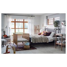 a baby's room with a crib, rocking chair, and other furniture