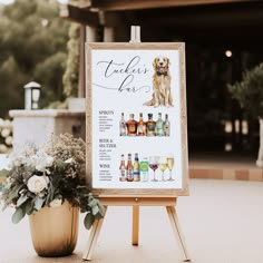 a sign that is sitting on top of a wooden easel next to a potted plant