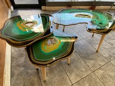 three tables sitting on top of a tiled floor next to each other in front of a window