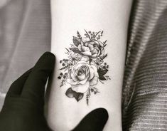 a woman's arm with a rose tattoo on the left side of her body