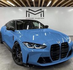 a blue sports car is parked in a showroom