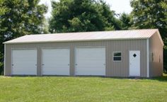 two garages in the middle of a grassy field