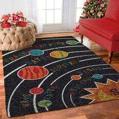 an area rug with planets on it in front of a red chair and christmas tree