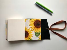 an open notebook with sunflowers on it