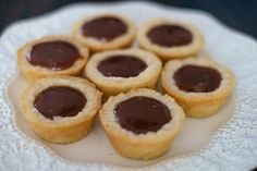 small cookies with chocolate filling on a white plate