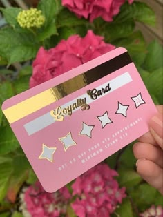 a person holding up a pink card with stars on it and the words enjoy band