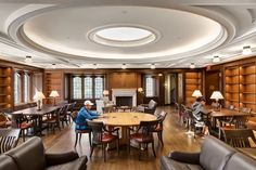 a large library filled with lots of wooden furniture