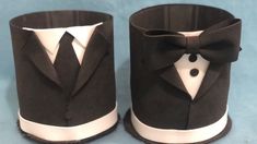 two black and white paper cups with tuxedos on them, one has a bow tie