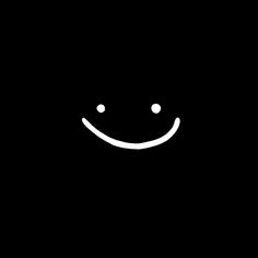 a black background with a smiley face drawn in the middle and two white dots at the bottom