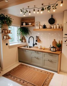 a kitchen with lots of pots and pans on the shelves above the stove top