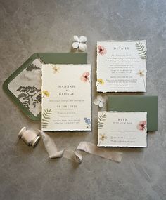 the wedding stationery is laid out on the table