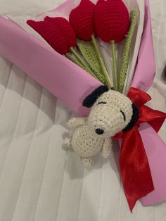 a crocheted stuffed dog and some flowers