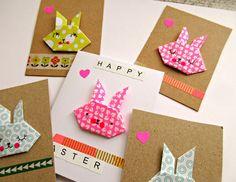 some paper animals are on top of brown cards with pink and green designs, one is for easter