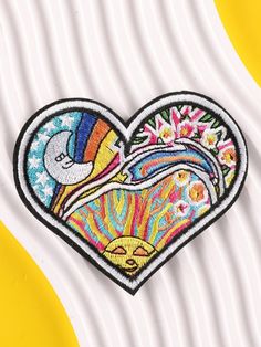 a heart shaped patch with colorful designs on it