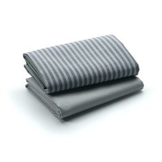 two sheets folded on top of each other in grey and white striped linens,