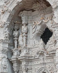 an ornate white building with black windows