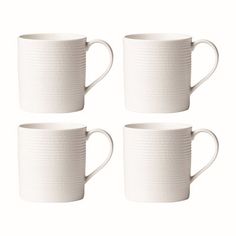 four white coffee mugs sitting next to each other