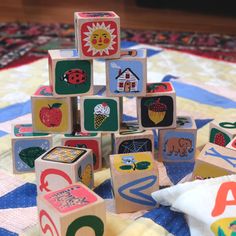 several wooden blocks are arranged in the shape of a tree on a quilted surface