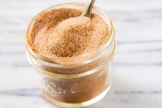 a spoon in a jar filled with brown sugar