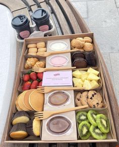 a wooden table topped with lots of different types of foods and desserts on top of it