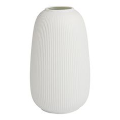 a white vase sitting on top of a table