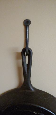 an old cast iron skillet hanging on the wall