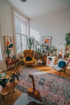 a living room filled with furniture and plants