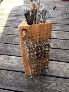 a wooden holder with many tools in it