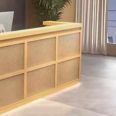 a wooden desk with a laptop on top of it in front of a large window