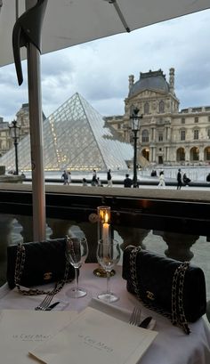 the table is set with an umbrella and wine glasses