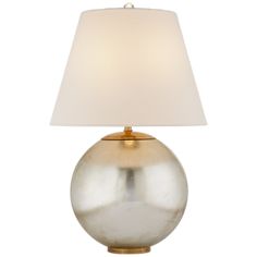 a silver lamp with a white shade on it's side and a gold base