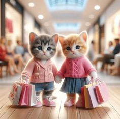 two small kittens dressed in sweaters and shoes holding shopping bags while standing next to each other