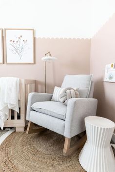 a baby's room with a rocking chair, crib and rugs on the floor