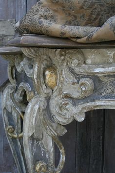 an old, worn and weathered table with a cloth draped over it's top